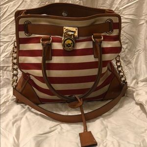 A striped Miicheal Khors purse